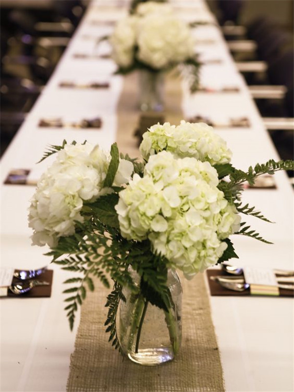 Mason jars on a burlap runner