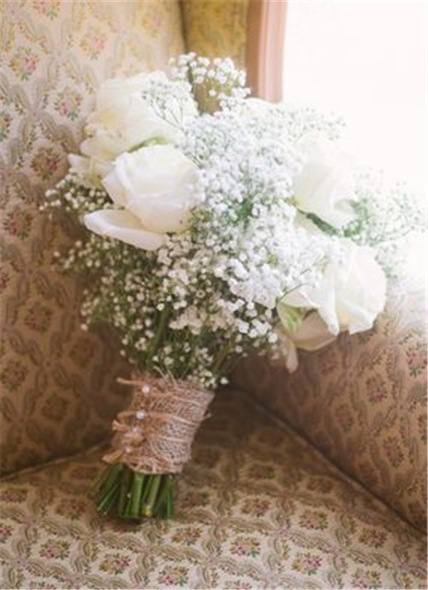 White Rose and baby's breath switch the burlap for satin and pearl pins wrapped around the bouquet