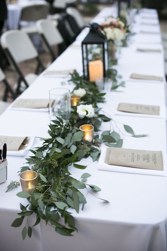 Greenery garland down the head table made with seeded eucalyptus and rosemary