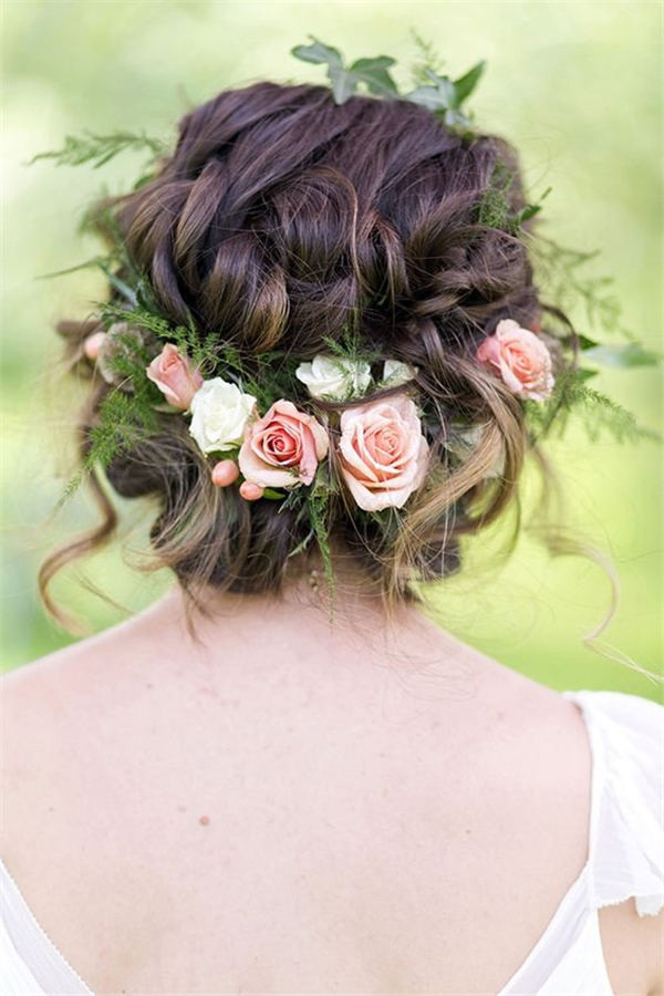 Bridal hairstyle with greenery and flowers