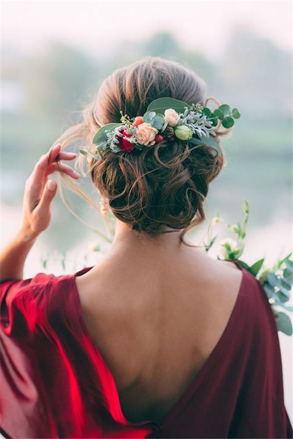 Greenery and floral adorned wedding hair updo