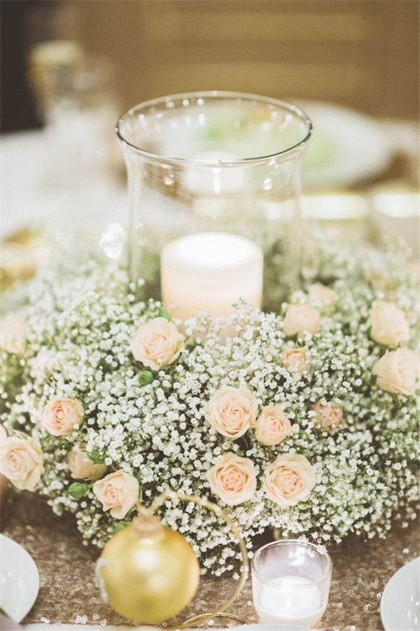 Sweet and charming centerpiece with Baby's breath and champagne spray roses