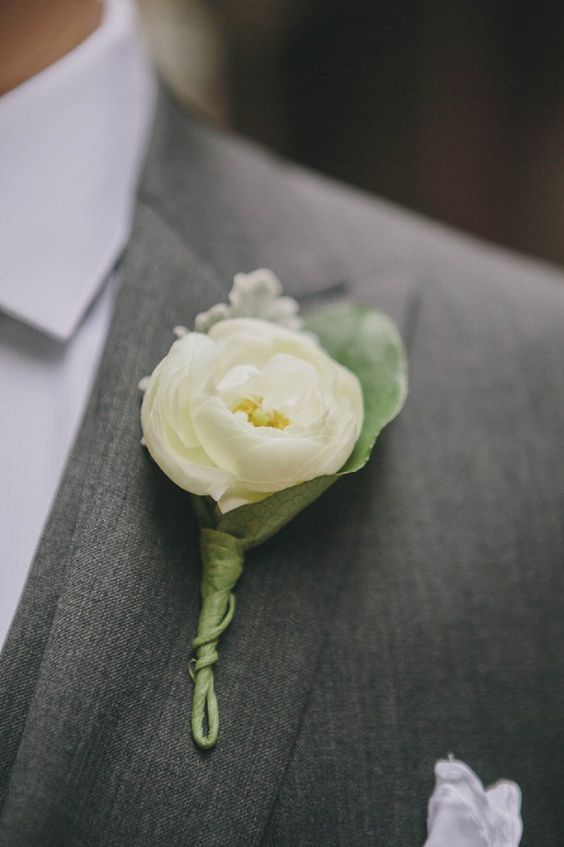 White ranunculus boutonniere for the groom