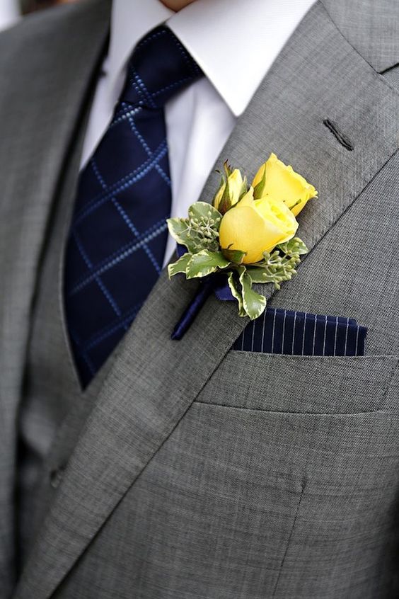 Yellow spray roses and variegated pittosporum boutonniere