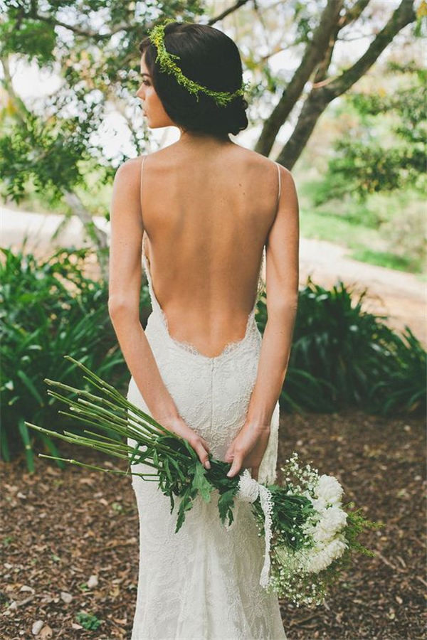 backless bohemian wedding gown and greenery wedding hair decor