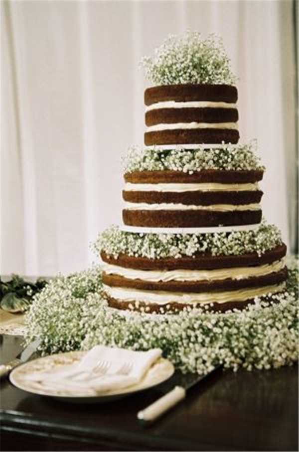 gorgeous 'naked' wedding cake with baby's breath