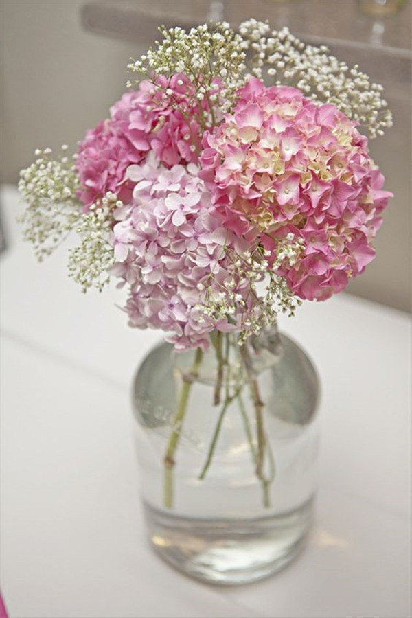 pink hydrangeas and baby's breath in glass vase