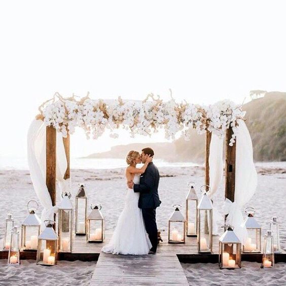Beautiful! Love the flowers and lanterns and the finished look with the risers in the sand!