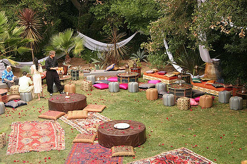 Bohemian wedding receptionwith mismatched rugs and low tables