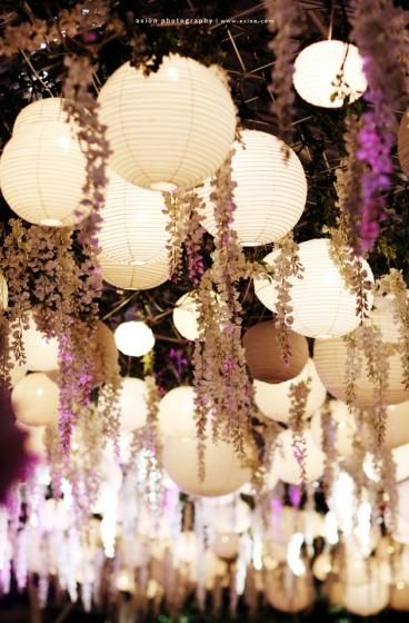 Hanging lanterns and flowers for boho wedding reception decor