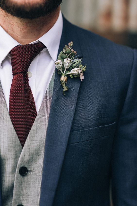 Navy groom suit with grey vest burgundy knit tie and gumnut boutonniere