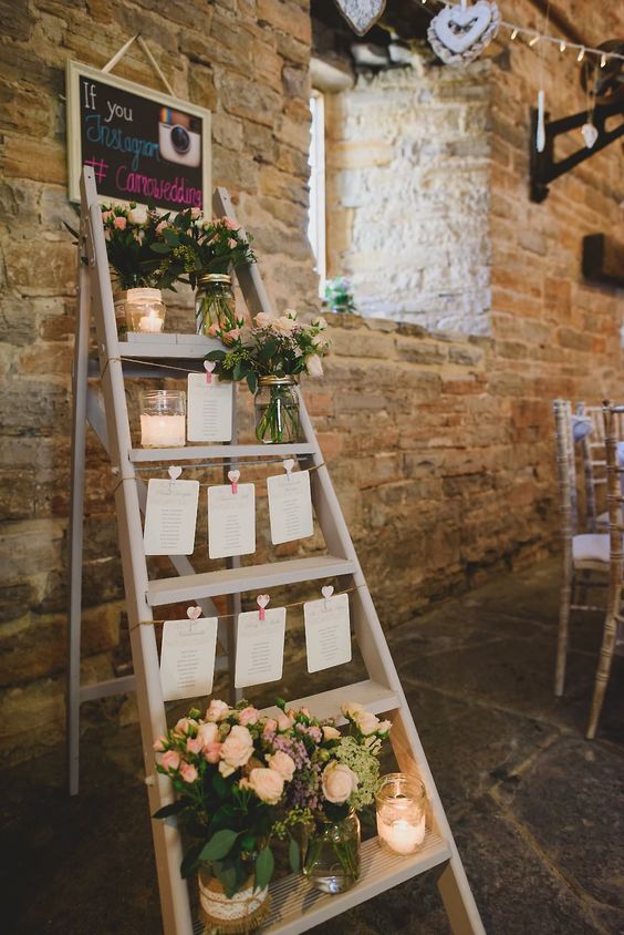 Step ladder table plan with candles and glass jars filled with flowers