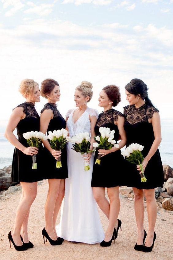 bridesmaids in black with white bouquets