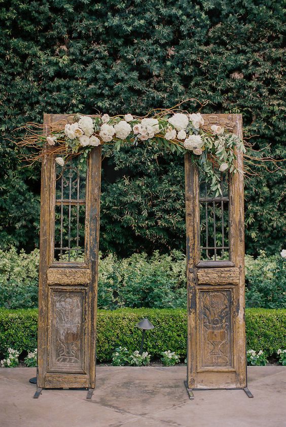 Old wooden doors with florals for a vintage ceremony backdrop