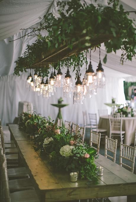 backyard tent wedding with simple greenery chandelier