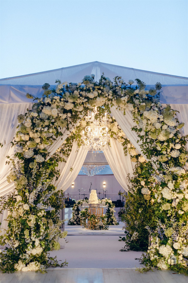 Floral entrance for outdoor tent wedding