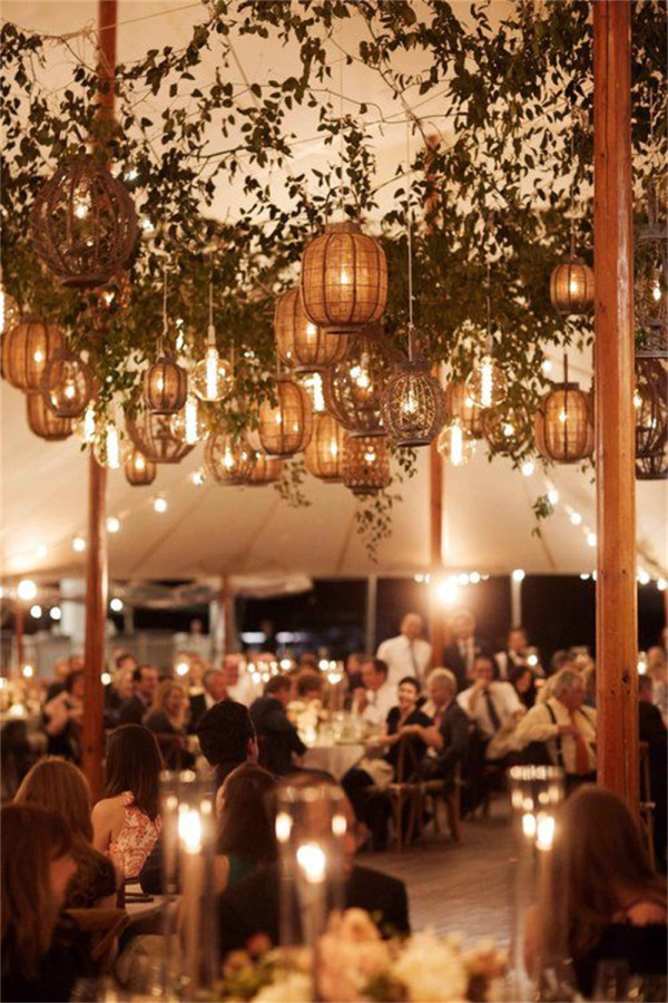 tent wedding ceiling with lanterns and greenery