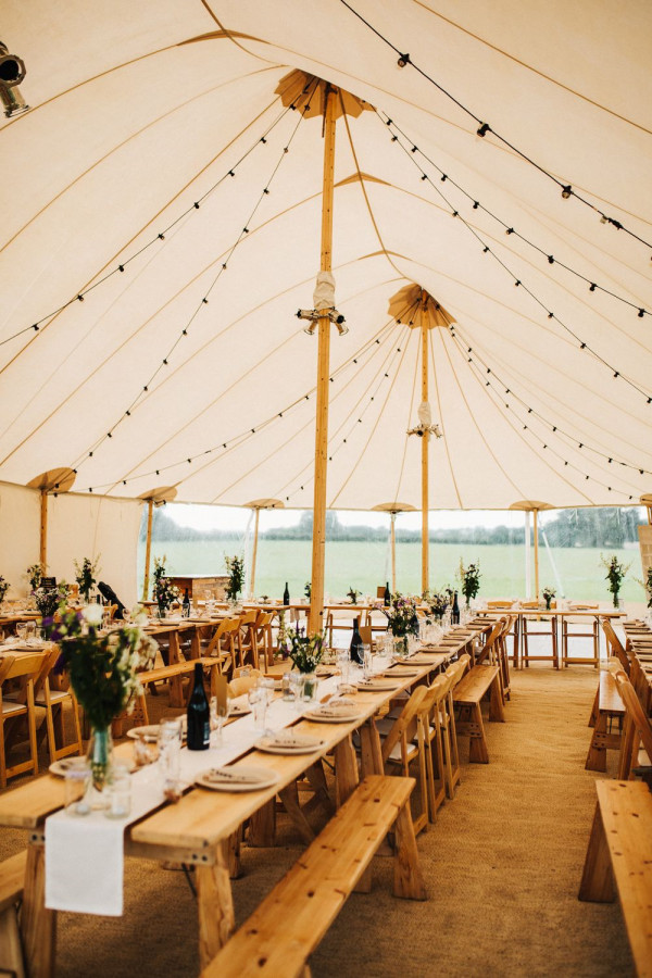 tent wedding reception with wood tables